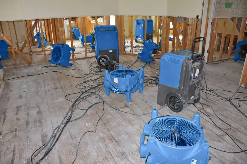 Air movers drying a gutted Apopka room after major water damage